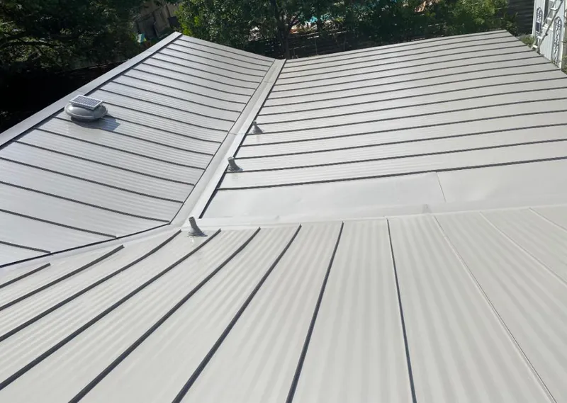 Solar attic fan installed on a metal roof for Roof Ventilation in Upper